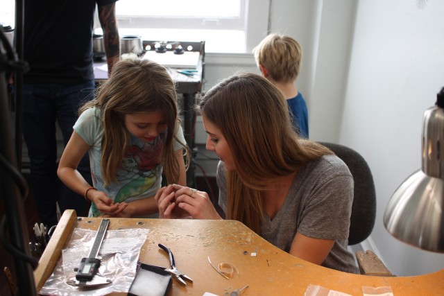 Alexei's assistant, Anna, shows Erin some metal that will be made into a ring.